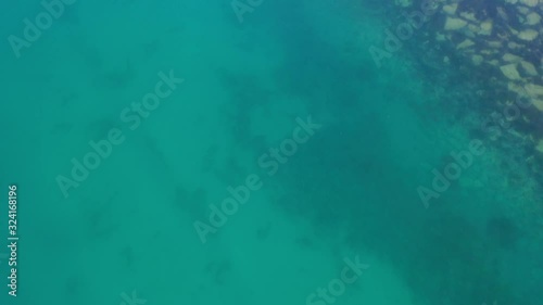 Wallpaper Mural Pan up from beautiful clear blue green ocean water to the sea with boats and distant snowy mountains Torontodigital.ca