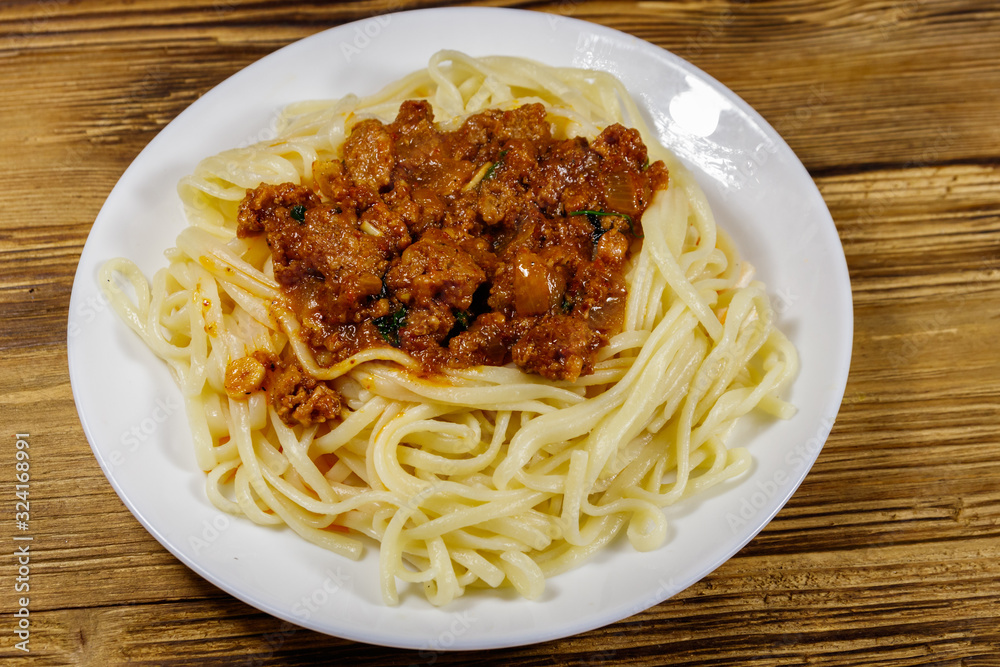 Pasta with bolognese sauce on wooden table Pasta with bolognese sauce on wooden table