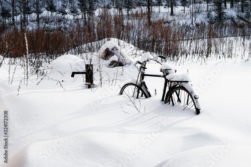 A bicycle covered with white snow in winter © xu