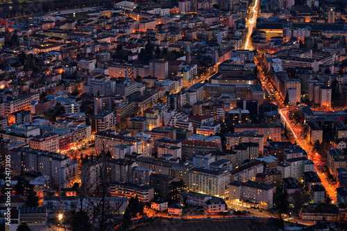 Night Skyline view of district Bolzano city Alto Adige, Province Bolzano, South Tyrol, Italy. Europe. City lights. Cityscape in mountains. Twilight in mountains. City twilight. Evening in mountains