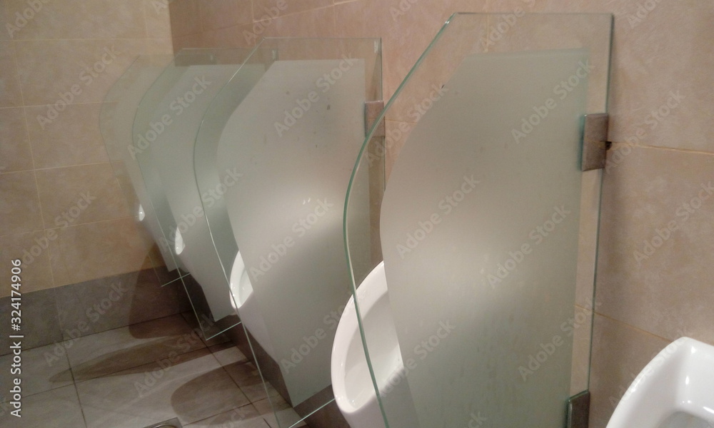 Urinals and glass partition with frosted film for privacy purpose in