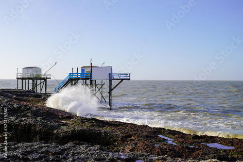 Fishing huts wooden with nets in wave water sea Saint-Palais-sur-Mer photo