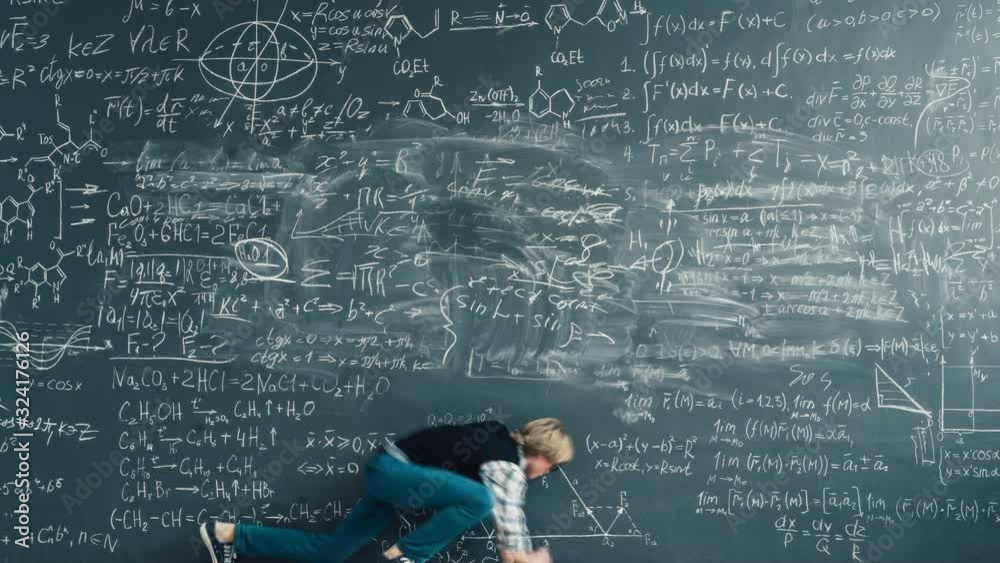 Zoom-in time-lapse of smart person solving scientific problem writing formulas on chalkboard focused on studies. People and knowledge concept.