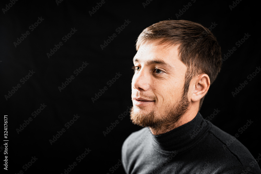 Portrait of a bearded handsome man on a black background