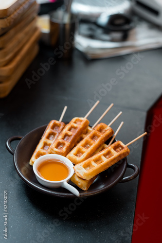 homemade waffles stick with maple syrup in mini cafe