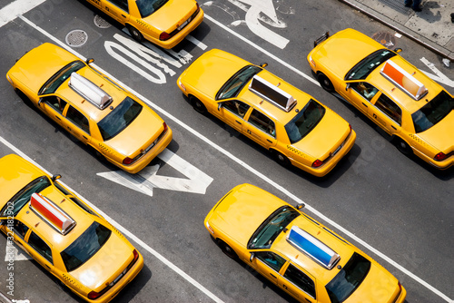 Fotografia, Obraz View from above of fleet of yellow taxi cabs driving down the street of Broadway