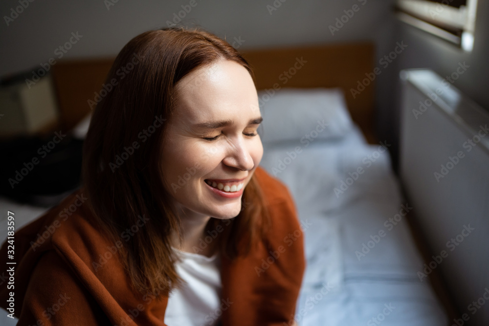 girl brown hair in hoodie laughs with eyes closed girl brown hair in hoodie laughs with eyes closed