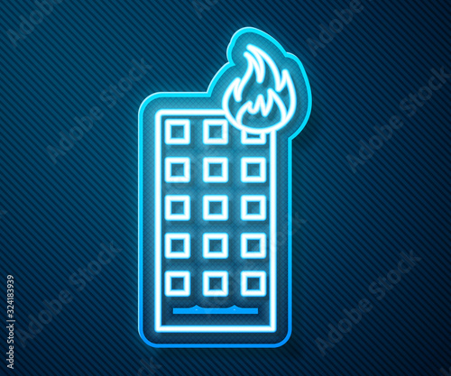 Glowing neon line Fire in burning building on city street icon isolated on blue background. Vector Illustration