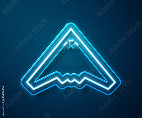 Glowing neon line Jet fighter icon isolated on blue background. Military aircraft. Vector Illustration