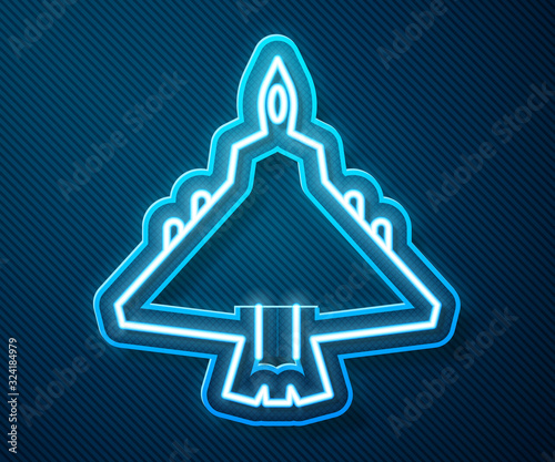 Glowing neon line Jet fighter icon isolated on blue background. Military aircraft. Vector Illustration