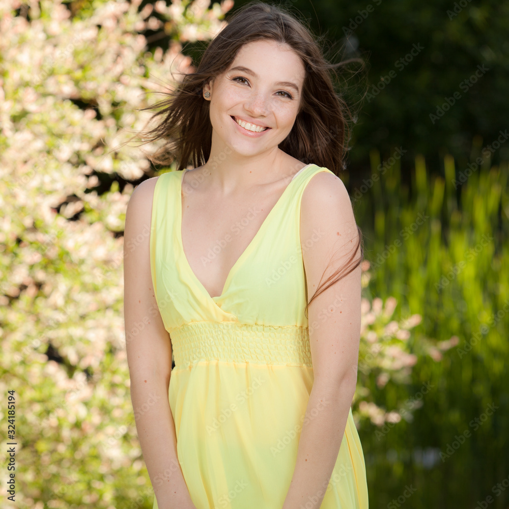 Portrait of beautiful young girl in summer garden.
