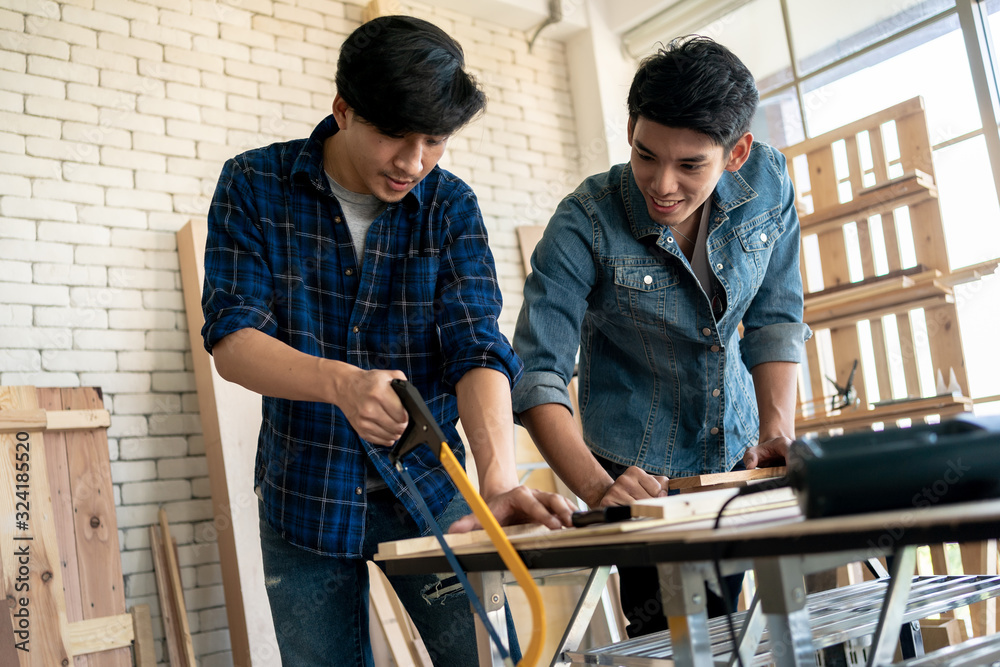 Two young carpenters working at location.