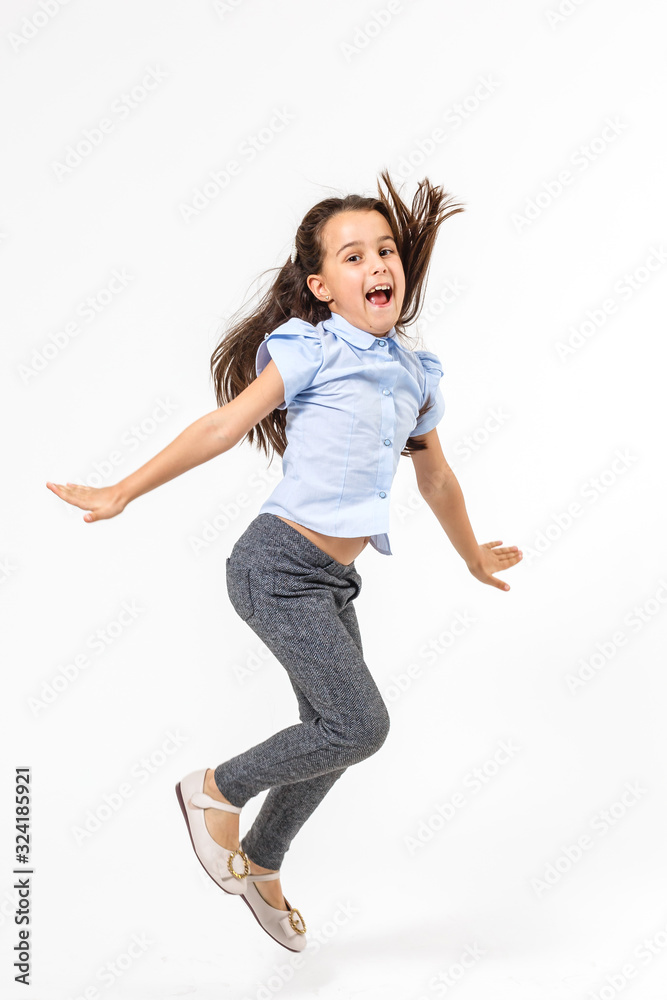 little girl jumps on a white background
