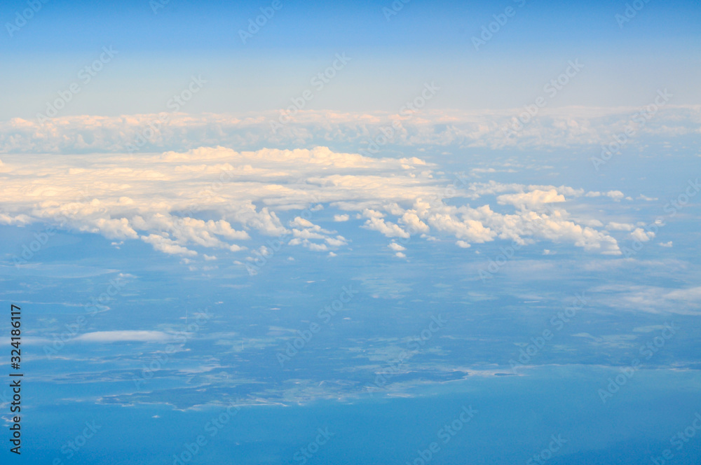 Clouds with ground and sea in the background Clouds with ground and sea in the background