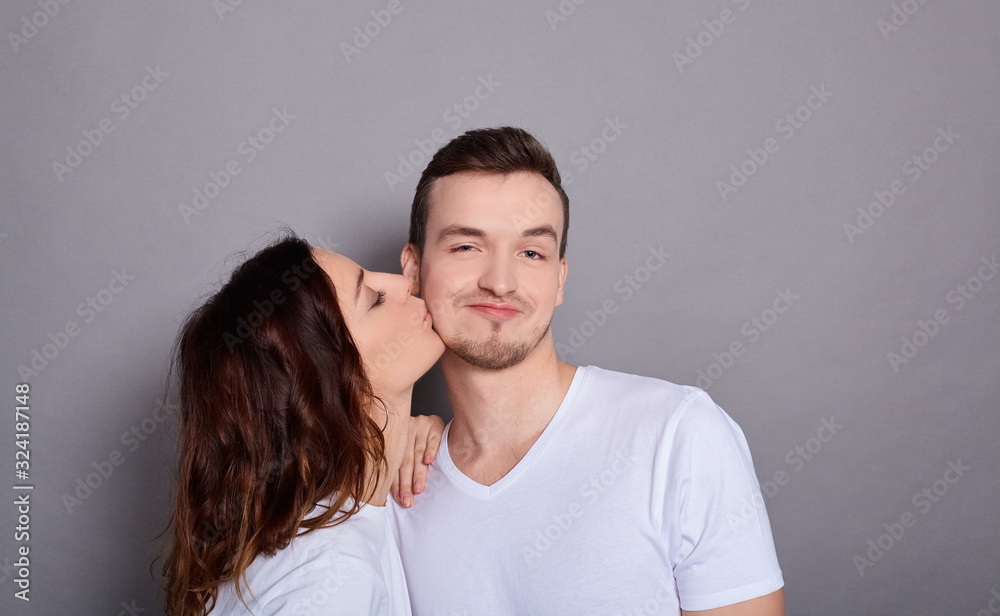 Cheerful smiling couple in love hug and kiss. Cheerful smiling couple in love hug and kiss.