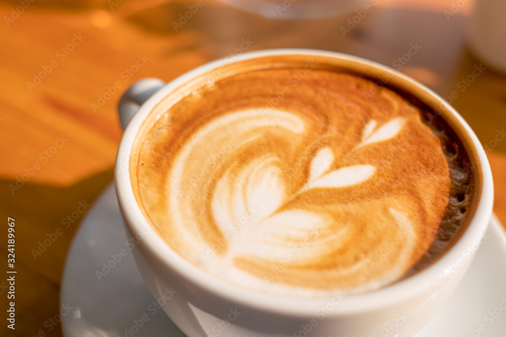 closeup latte art coffee leaf and heart shape in a classic white coffee cup closeup latte art coffee leaf and heart shape in a classic white coffee cup