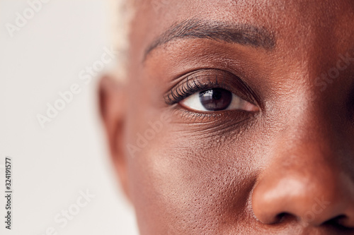 Close Up On Eyes Of Young Woman With Dyed Hair In Studio photo