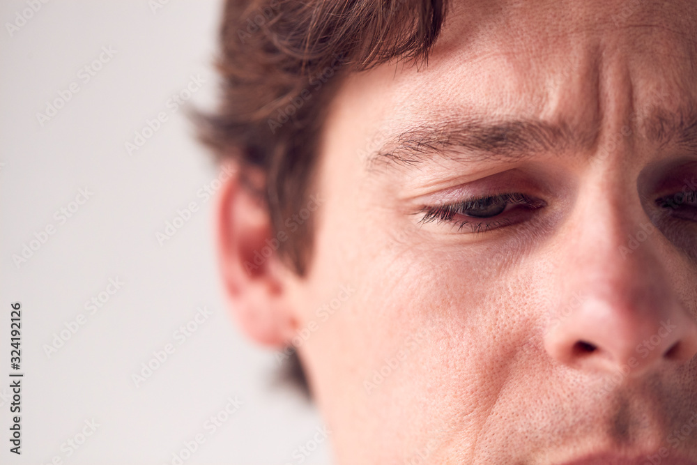 Close Up On Face Of Unhappy Man Shot In Studio Close Up On Face Of Unhappy Man Shot In Studio