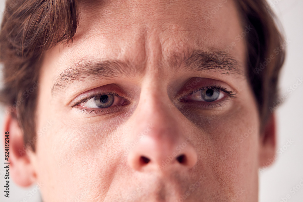 Close Up On Face Of Unhappy Man Shot In Studio Close Up On Face Of Unhappy Man Shot In Studio