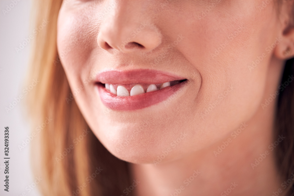 Obraz premium Close Up On Mouth Of Smiling Young Woman In Studio