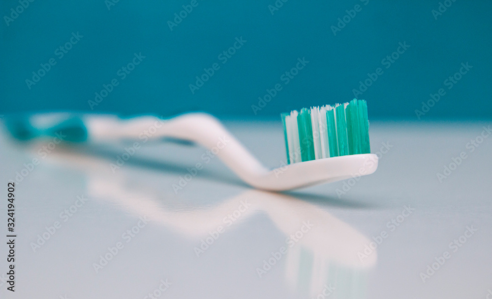 strong toothbrush close-up on a light background with reflection strong toothbrush close-up on a light background with reflection