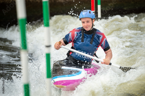 Close up of a happy GB Canoe Slalom Athlete negotiating the poles of slalom gates on white water in the C1W class photo