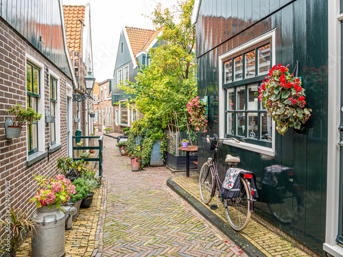 Bicycle in small street Kerkepad in Volendam, Noord-Holland, Netherlands photo