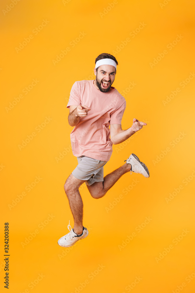 Image of muscular athletic young man having fun while doing workout