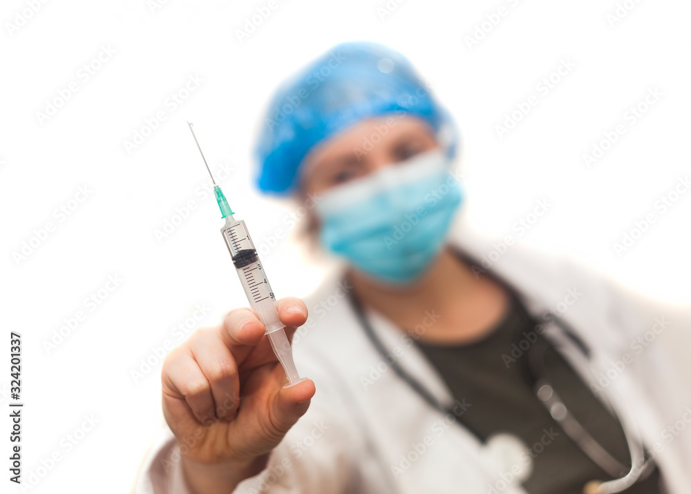 nurse woman holding syringe for virus protection. focus on the hand