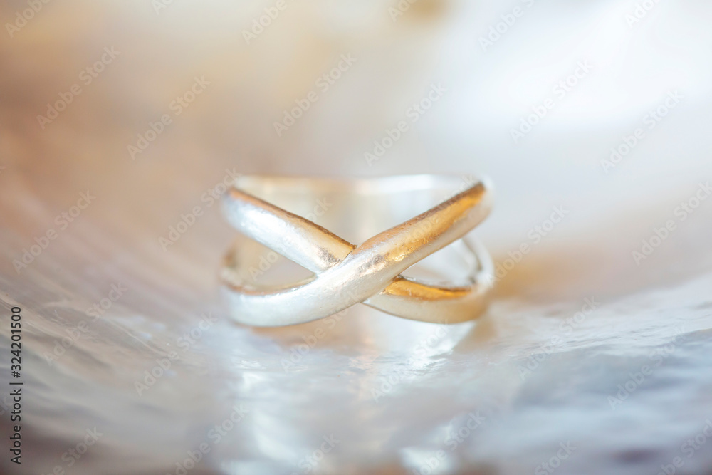 Sterling silver ring on pearl shell white background Sterling silver ring on pearl shell white background