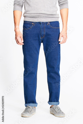 Male model in blue jeans bottom on white background.