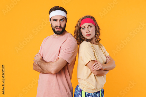 Portrait of offended couple frowning and standing with arms crossed © Drobot Dean