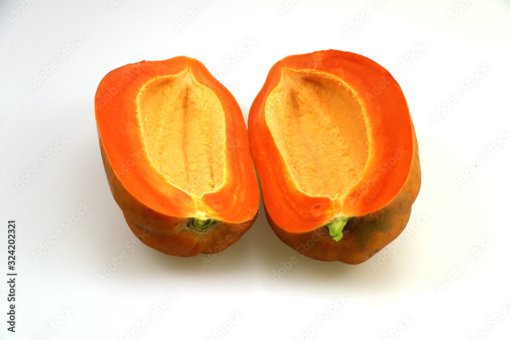 Yellow papaya, cut in half, white background