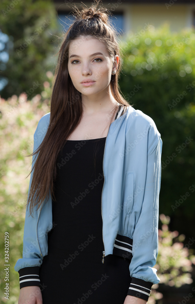 Portrait of beautiful young girl in summer garden. Portrait of beautiful young girl in summer garden.