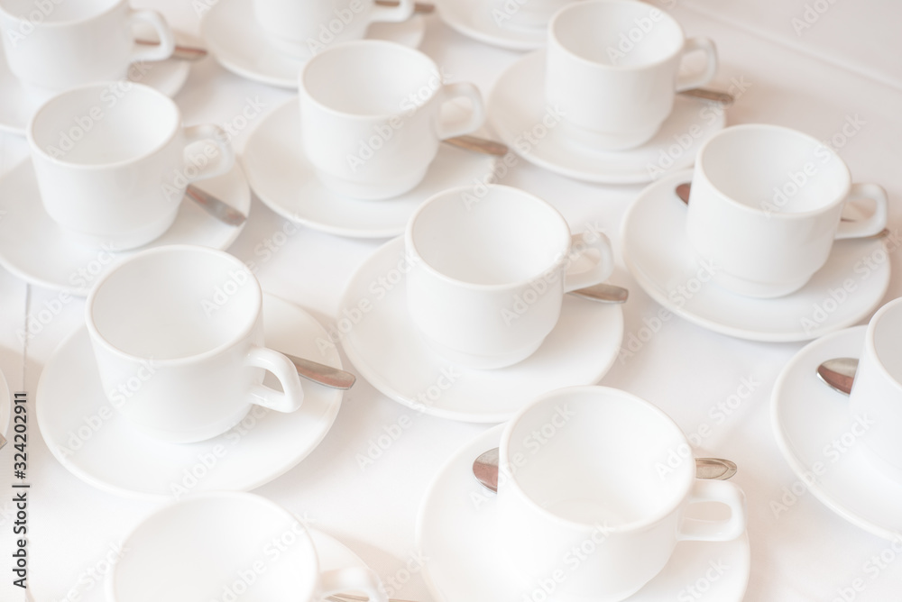 Group of coffee cups in cafe bar on the white tablecloth