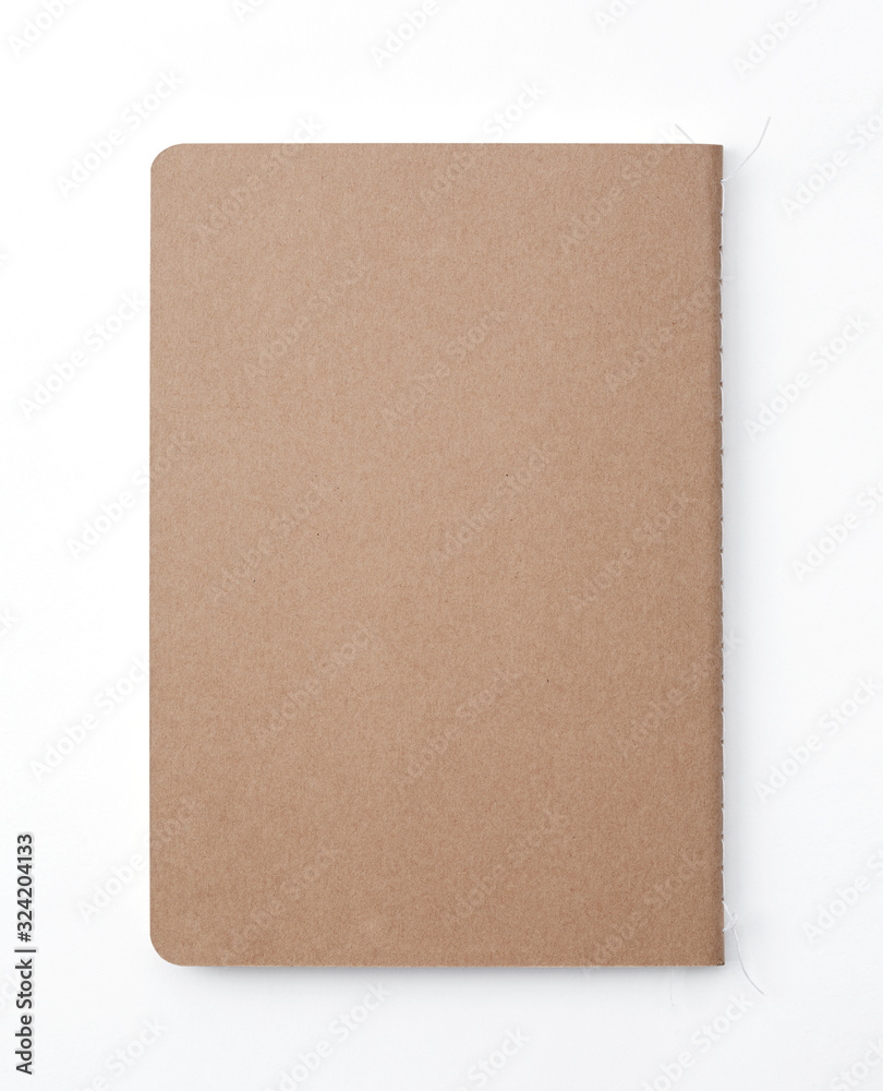 Top view of closed stitch blank recycled paper cover notebook on white background. Top view of closed stitch blank recycled paper cover notebook on white background.