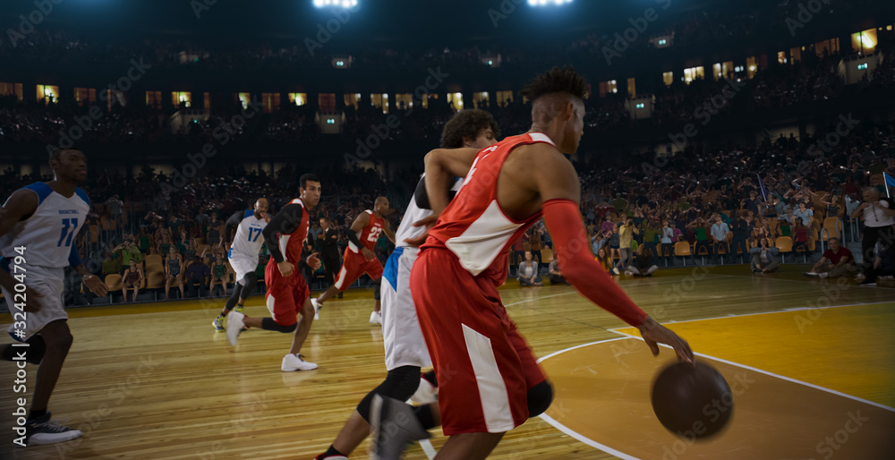 Fototapeta premium Basketball players on big professional arena during the game. Tense moment of the game. 