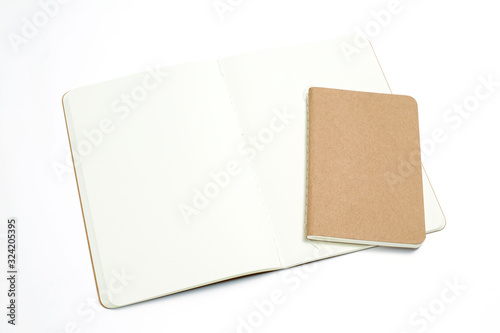 Top view of open stitch blank recycled paper cover notebook on white background .