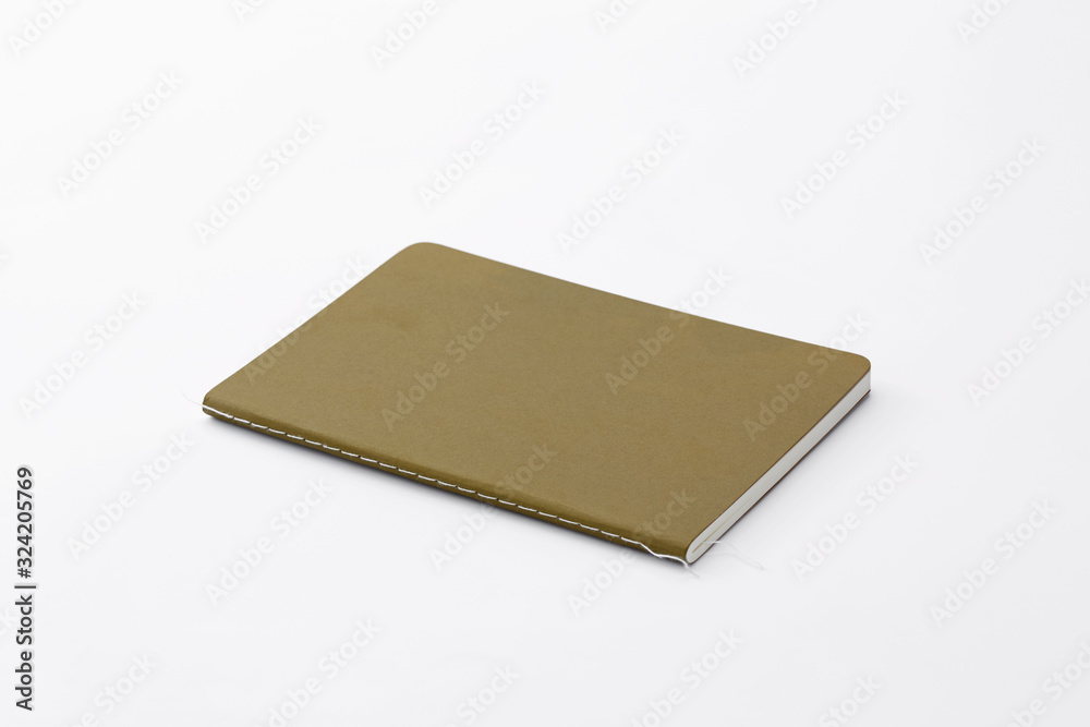 Top view of closed stitch blank recycled paper cover notebook on white background. Top view of closed stitch blank recycled paper cover notebook on white background.