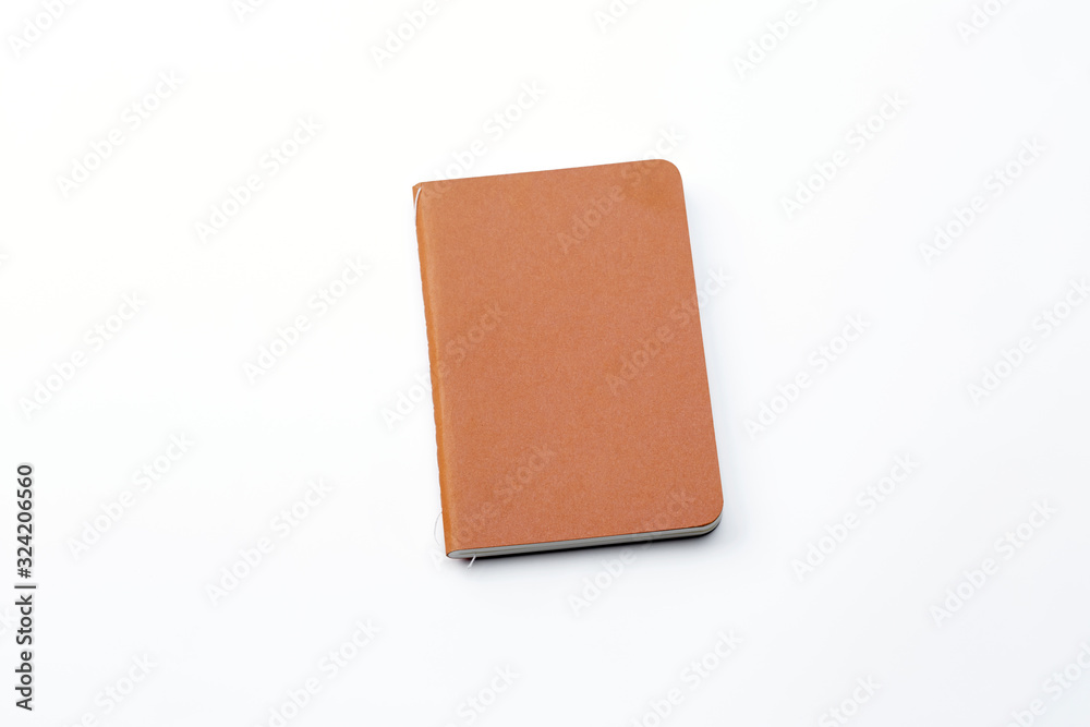 Top view of closed stitch blank recycled paper cover notebook on white background. Top view of closed stitch blank recycled paper cover notebook on white background.