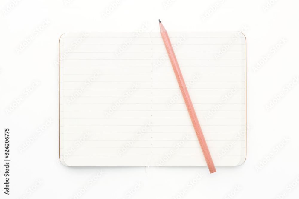 Top view of closed stitch blank recycled paper cover notebook with pencil on white background. Top view of closed stitch blank recycled paper cover notebook with pencil on white background.