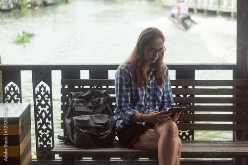 Photography Women backpack tourists travel in the market with a lot of people , tourism conc