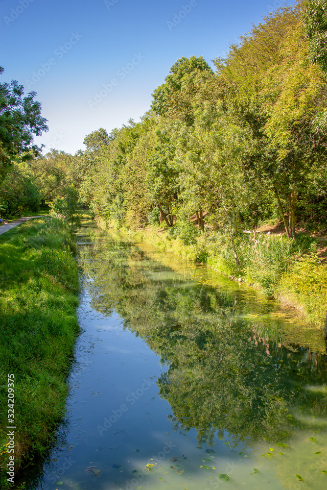 Water canal in public park Charruyer, La Rochelle, France Water canal in public park Charruyer, La Rochelle, France