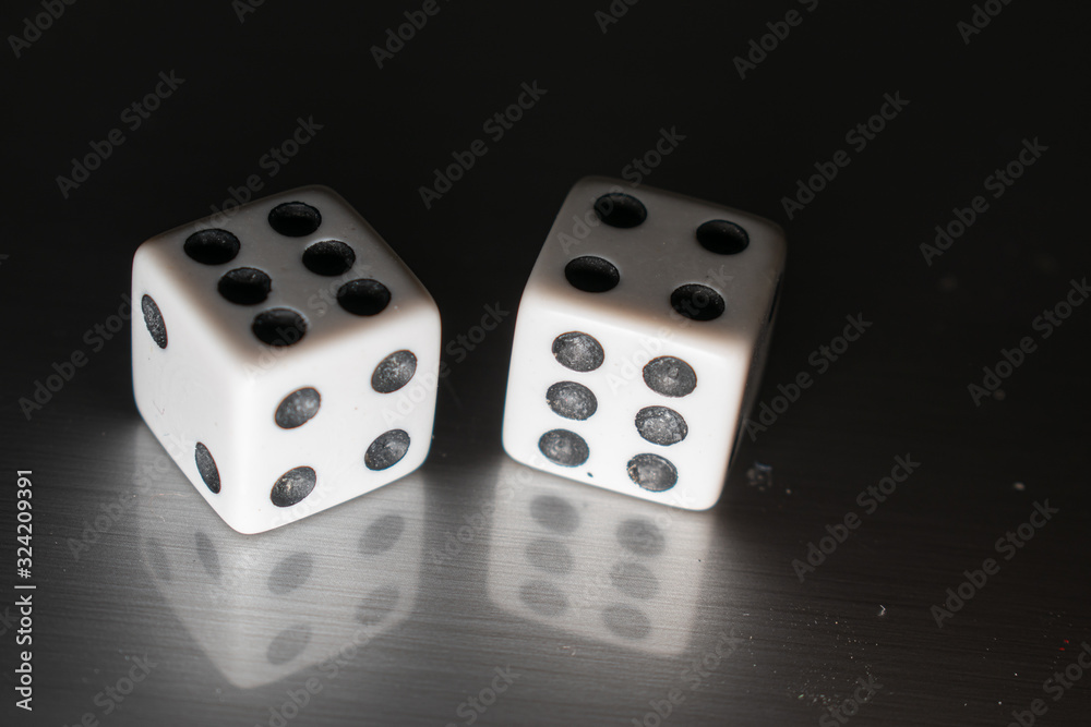 Closeup of a pair of dice on a reflective surface, with winning numbers and reflection bellow them. Closeup of a pair of dice on a reflective surface, with winning numbers and reflection bellow them.