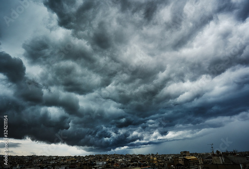 Dark clouds before the storm; thick clouds hovering over a city