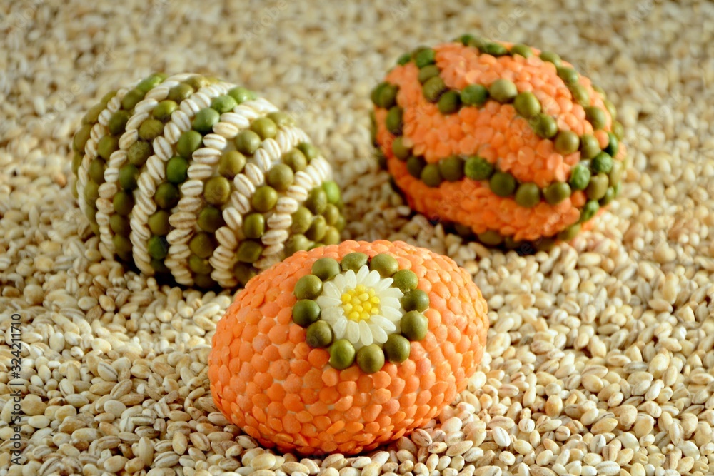 Amazing Easter eggs decorated with a mosaic of cereals  on  background оf grains