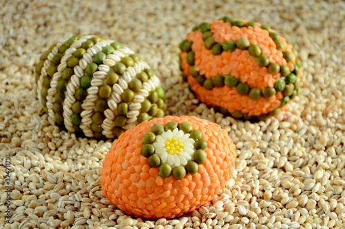 Amazing Easter eggs decorated with a mosaic of cereals on background оf grains