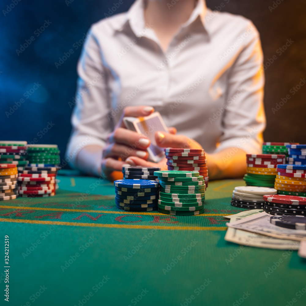 Playing poker in a big casino. Online business playing cards, big bets and money. Casino background. Winning and success, risk and fortune. Playing poker in a big casino. Online business playing cards, big bets and money. Casino background. Winning and success, risk and fortune.