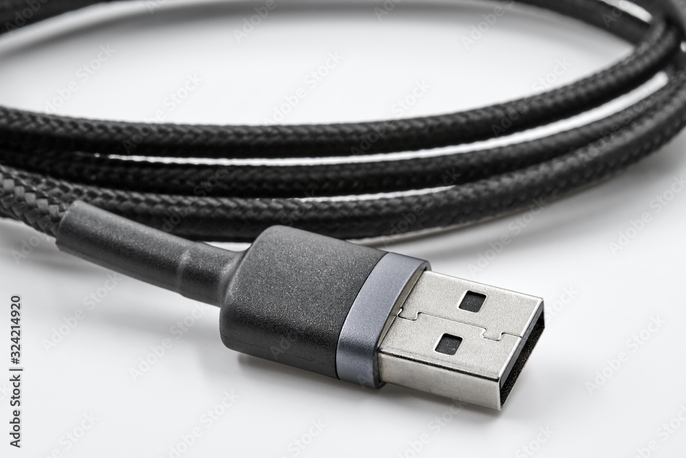 Black USB data and power cable on white background. Closeup Black USB data and power cable on white background. Closeup