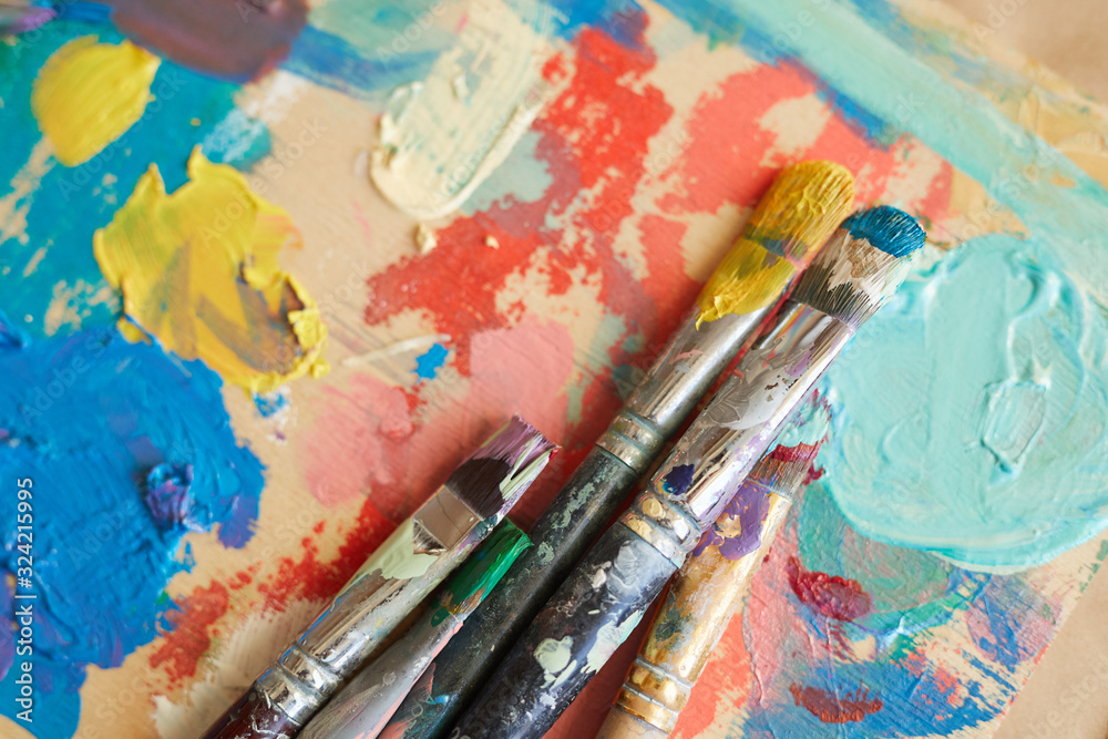 Close-up of finished watercolor painting with paintbrushes on the table Close-up of finished watercolor painting with paintbrushes on the table
